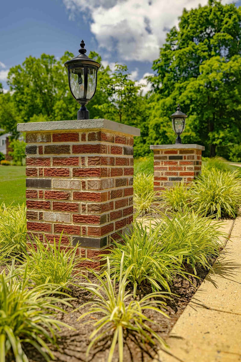 Brick pillar with lamp and ornamental grasses, Greenville Delaware