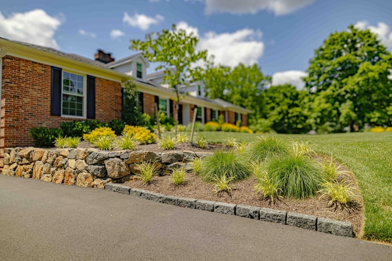 Natural stone retaining wall with ornamental grasses, Greenville DE