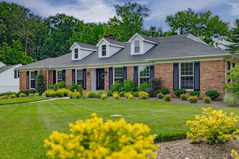 Greenville Delaware home with refreshed front landscaping and yellow shrubs