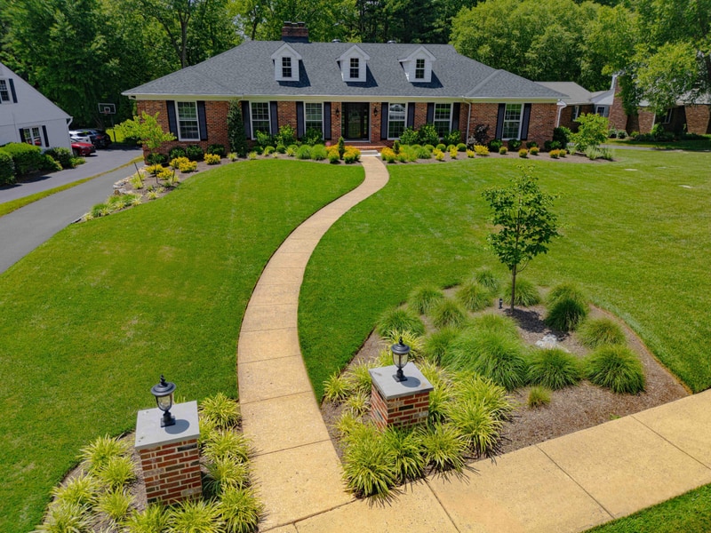 Aerial of walkway and brick pillars approaching Greenville DE home