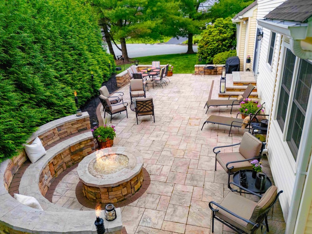 Nature's Call Landscaping hero. Flagstone patio with stone fire pit, Northern Delaware.